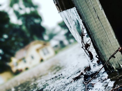 Overflowing gutter on a home during heavy rain